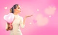 Valentine`s day. Beauty girl with pink heart shaped air balloon pointing hand Royalty Free Stock Photo