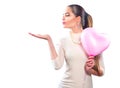 Valentine`s day. Beauty girl with pink heart shaped air balloon pointing hand Royalty Free Stock Photo