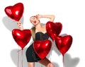 Valentine`s Day. Beauty girl with red heart shaped air balloons having fun, isolated on white Royalty Free Stock Photo