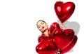 Valentine`s Day. Beauty girl with red heart shaped air balloons having fun, isolated on white Royalty Free Stock Photo