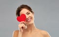 Beautiful smiling woman holding red heart Royalty Free Stock Photo