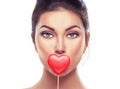 Valentines Day. Beauty surprised young fashion model girl with Valentine heart shaped cookie