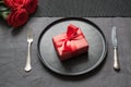 Valentine`s day or birthday dinner. Elegance table setting with red rose on black linen tablecloth Royalty Free Stock Photo