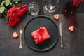 Valentine`s day or birthday dinner. Elegance table setting with red rose on black linen tablecloth Royalty Free Stock Photo