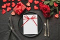 Valentine`s day or birthday dinner. Elegance table setting with red rose on black linen tablecloth Royalty Free Stock Photo