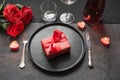 Valentine`s day or birthday dinner. Elegance table setting with red rose on black linen tablecloth Royalty Free Stock Photo