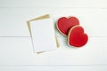 Valentine`s day blank greeting card mockup with paper envelope and red heart on white wooden table Royalty Free Stock Photo