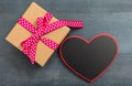 Valentine`s day. A blank heart shape board and a gift box on blue background, copy space, top view Royalty Free Stock Photo