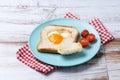 Valentine\'s Day breakfast with egg with tomatoes, heart shaped and toast bread