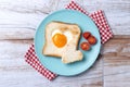 Valentine\'s Day breakfast with egg with tomatoes, heart shaped and toast bread on wooden table