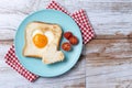 Valentine\'s Day breakfast with egg with tomatoes, heart shaped and toast bread on wooden table