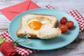 Valentine\'s Day breakfast with egg with tomatoes, heart shaped and toast bread on wooden table