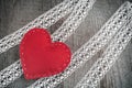 Valentine`s day card. Red felt heart on lace and wooden table background with copy space. Royalty Free Stock Photo