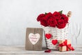 Valentine`s day card with red roses, gift box and champagne bottle Royalty Free Stock Photo