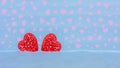 Valentine card with two red openwork hearts in a snowdrift on a blue background with pink hearts with space background Royalty Free Stock Photo