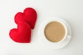 Valentine`s day card. White cup of hot coffee with milk and red felt heart. Top view. Royalty Free Stock Photo