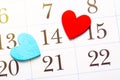 Valentine`s day, celebrating love concept. Red and blue hearts marking 14 february Valentines day on calendar page