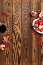 Valentine`s Day celebration concept. Top view vertical photo of plate with sweets cookies heart shaped candies and glass cup of Royalty Free Stock Photo