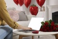 Valentine's day celebration in long distance relationship. Woman chatting with her boyfriend at home, closeup