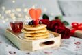 Valentine`s day composition with breakfast, gift box and roses. Stack of delicious pancakes with berries and cup of hot moning te Royalty Free Stock Photo