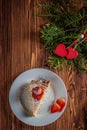 Cheesecake on Valentine`s Day with strawberry, kiwi hearts on fir and wood background