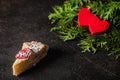 Cheesecake on Valentine`s Day with strawberry, kiwi hearts on fir and dark background