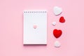 Valentine\'s day composition with notebook list and hearts on pink pastel background