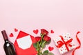 Valentine's day composition with red wine, rose flower and gift box on table. Top view, flat lay, copy space Royalty Free Stock Photo