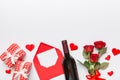 Valentine's day composition with red wine, rose flower and gift box on table. Top view, flat lay, copy space Royalty Free Stock Photo