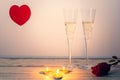 ValentineÃÂ´s day composition with two glasses of champagne, heart, rose and candles on white wooden background. Royalty Free Stock Photo