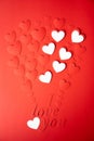 Valentine`s day concept. The background is red, the red hearts are cut out of paper. Words I love you Royalty Free Stock Photo