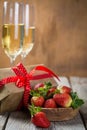 Valentine`s day concept - champagne, strawberry and present