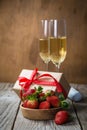 Valentine`s day concept - champagne, strawberry and present