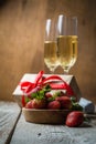 Valentine`s day concept - champagne, strawberry and present