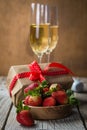 Valentine`s day concept - champagne, strawberry and present