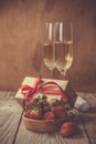 Valentine`s day concept - champagne, strawberry and present