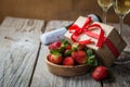 Valentine`s day concept - champagne, strawberry and present