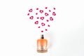 Bottle of perfume with red hearts flying out from it.