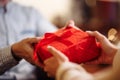 Valentine`s Day concept. Close shot of man`s and woman`s hands presenting gifts to each other at a cafe. A young loving couple Royalty Free Stock Photo