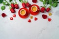 Valentine`s day concept with coffee cups, heart shape chocolate and rose flowers on bright background. Top view. Flat lay