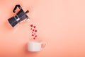 Valentine\'s day concept with coffee maker pouring hearts into a cup