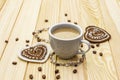 Valentine`s Day concept. Cup of coffee, knitted heart, string of pearl beads. Romantic breakfast and gift on wooden boards