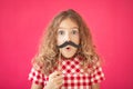 Funny girl with fake mustache against pink background