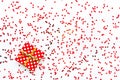 Valentine`s Day concept - a gift box over scattered heart shaped confetti background