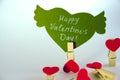 Valentine`s day concept. Green paper heart with wings and congratulation fixed on a clothespin and 4 heart shape Royalty Free Stock Photo