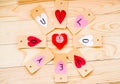 Valentine`s day holiday. hand made paper hearts labels on rustic background in circle with red origami heart inside Royalty Free Stock Photo