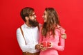 Valentine`s day concept. happy young couple with heart, flowers, gift on red Royalty Free Stock Photo