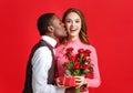 Valentine`s day concept. happy young couple with heart, flowers, gift on red Royalty Free Stock Photo