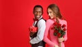 Valentine`s day concept. happy young couple with heart, flowers, gift on red Royalty Free Stock Photo