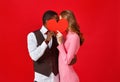 Valentine`s day concept. happy young couple with heart on red